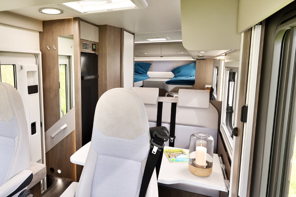 Carado motorhome interior with a dinette, swivel cab seats and rear bed