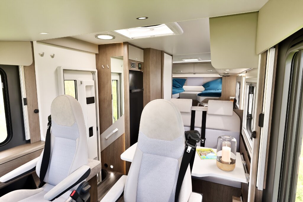 Carado motorhome interior with swivel front seats, seating area and rear bed