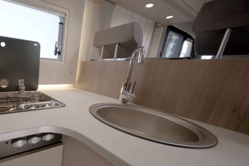Carado motorhome kitchen with sink, tap and gas hob beside the window