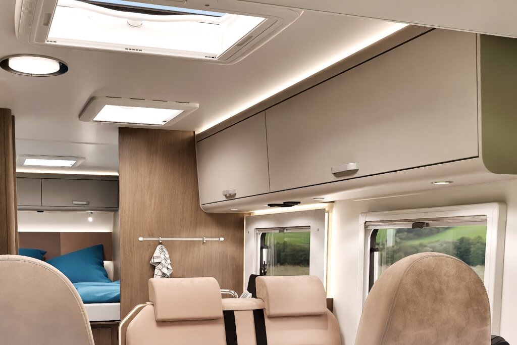 Carado motorhome interior with roof windows, overhead cabinets and seating in the front living area