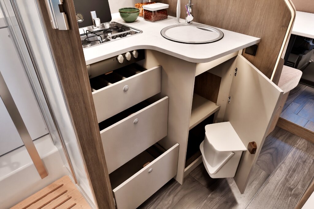 Carado motorhome kitchen with gas hob, sink, open drawers and storage space under the worktop