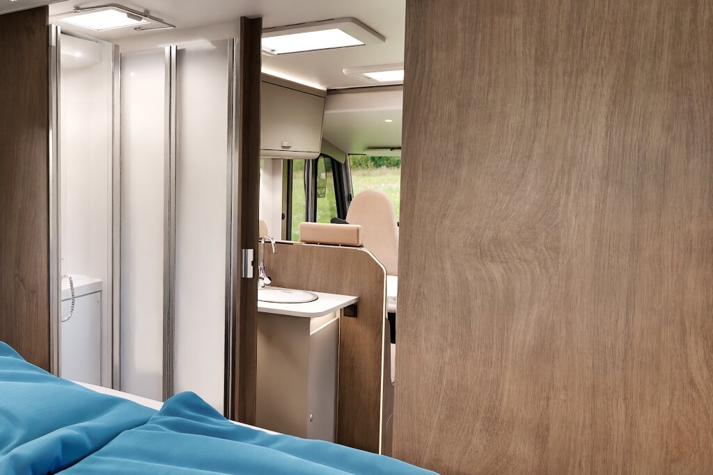 Carado motorhome interior with bathroom, washbasin and view from the bed to the front